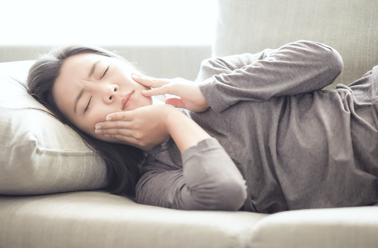 girl sleeping with a toothache 